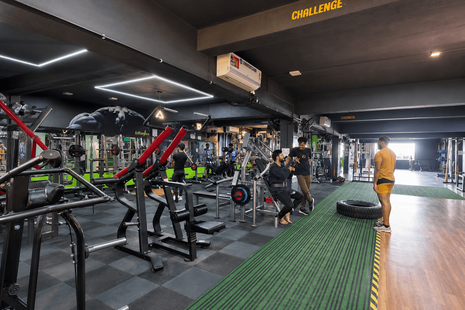 Members training on the iFitness machine floor