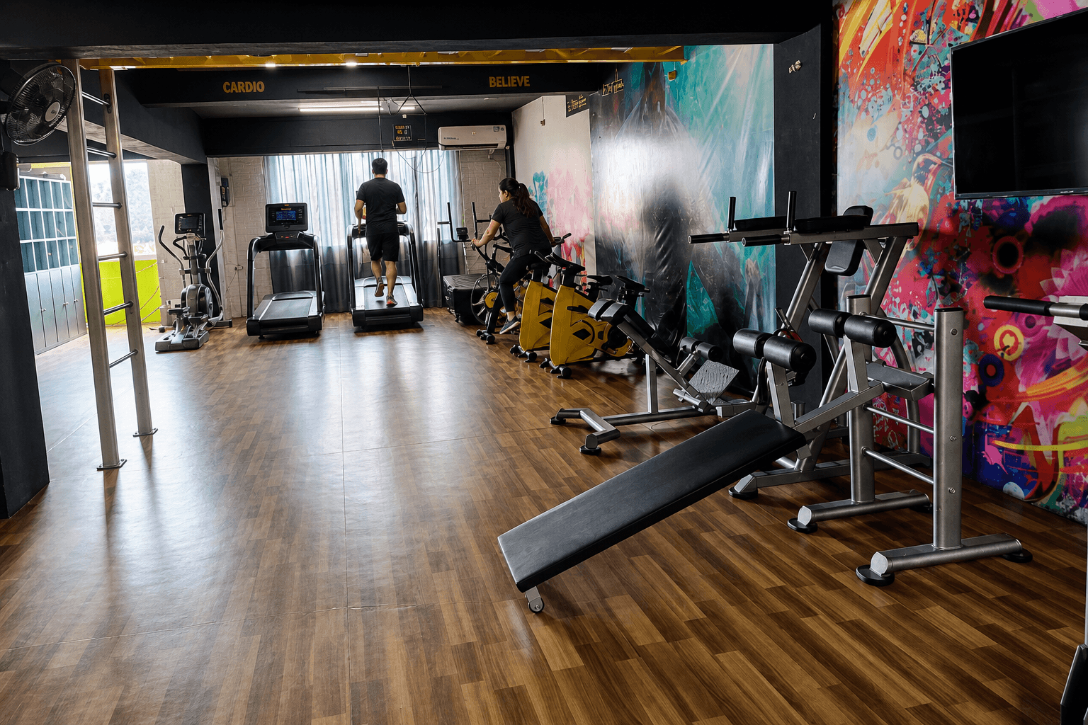Spin bikes and treadmills in a gym cardio room