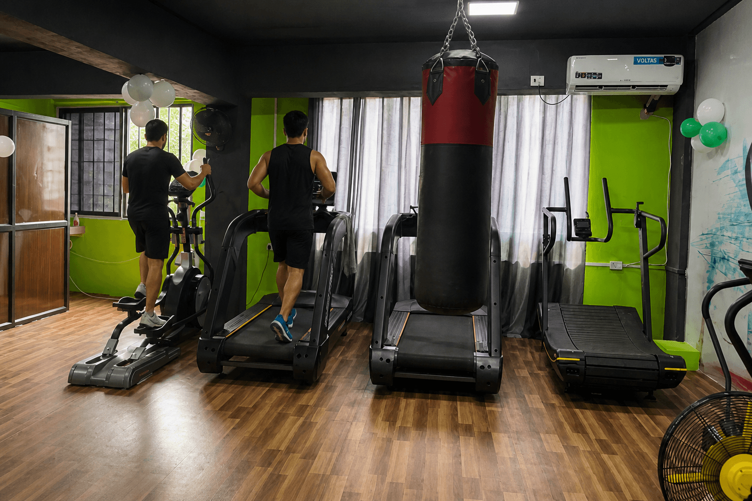 Treadmills and punching bag on a cardio floor