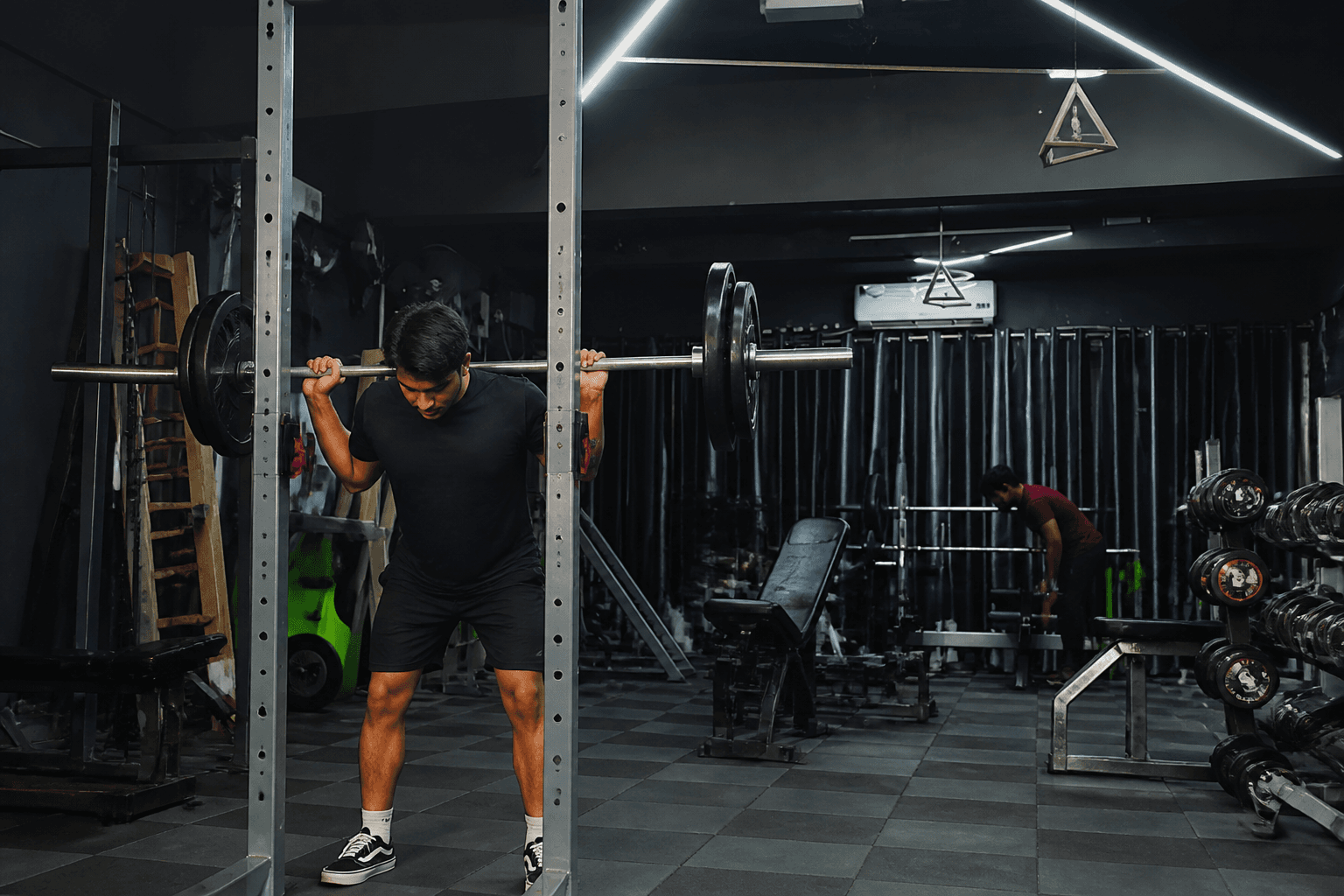 Squat rack training on a gym floor